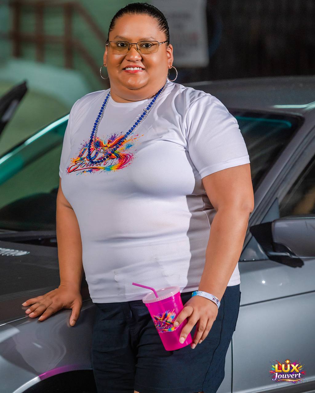 Reveller in a white LUX J'Ouvert tee with branded cup