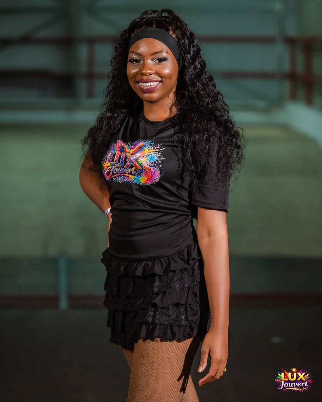 Reveller in a black LUX J'Ouvert tee and ruffle skirt